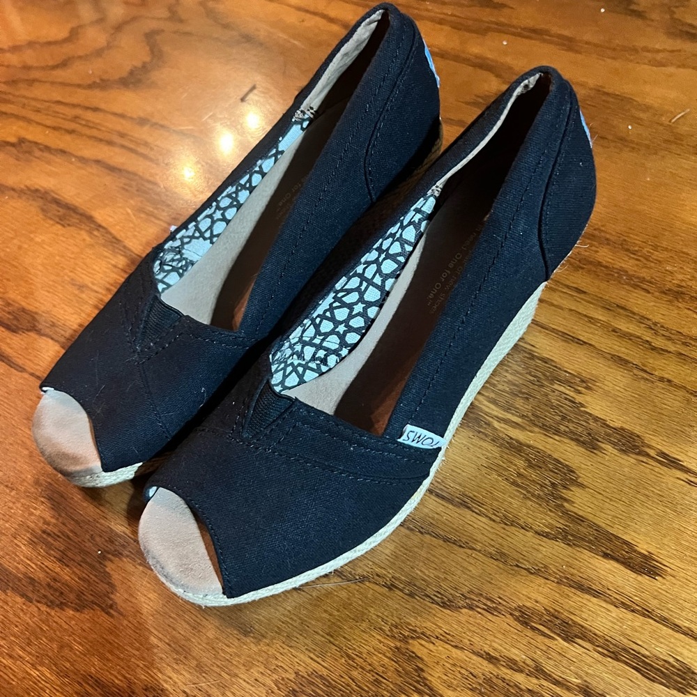Black canvas TOMS wedges. Sizes 6.5. Used.